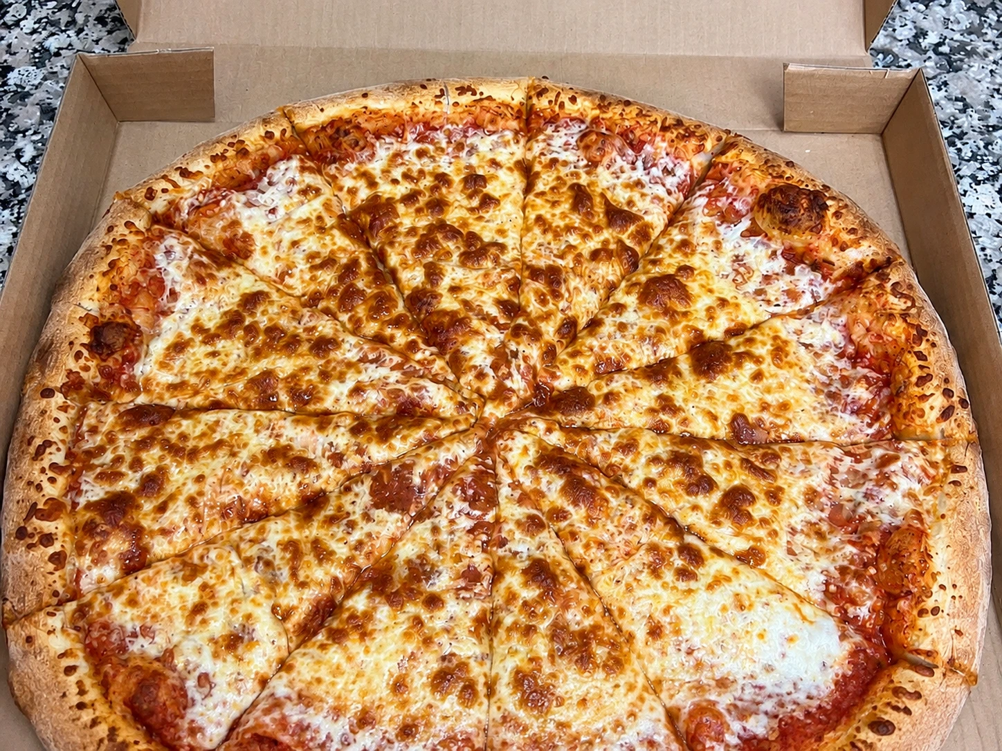 Cheese pizza fresh out of the box at Ancaster Pizza, Hamilton